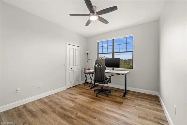 a view of a workspace with furniture and a window