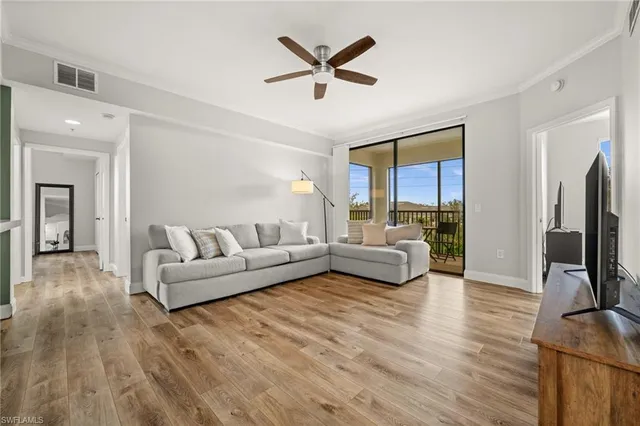 a living room with furniture window and a flat screen tv