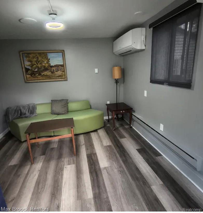 1392 Maple Grove Road Lapeer, MI 48446 - Photo 58 of 70 Sitting room featuring baseboard heating, light wood finished floors, and a wall mounted mini split