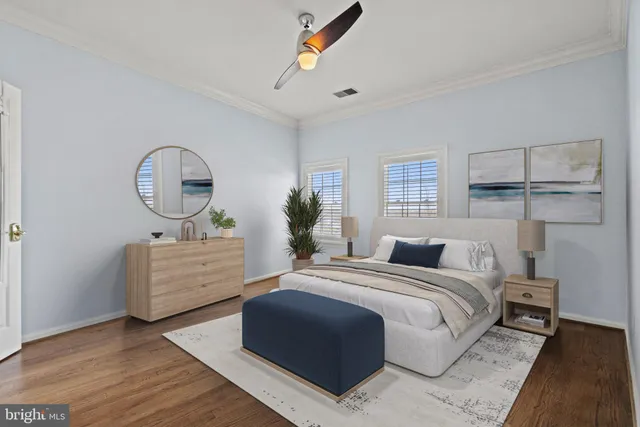 a bedroom with a bed a mirror and dresser