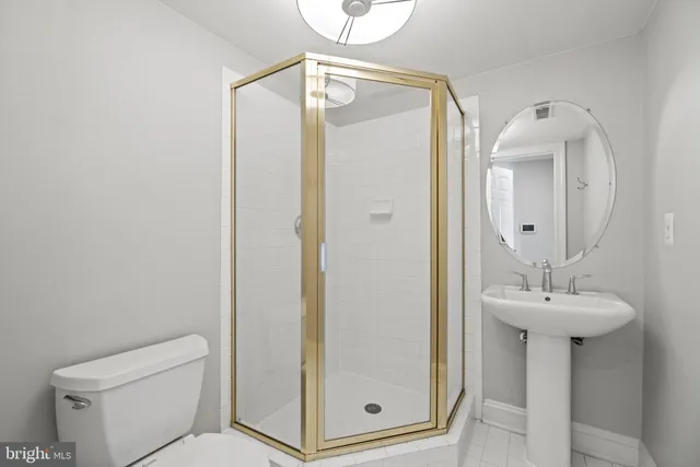 a bathroom with a sink mirror and toilet