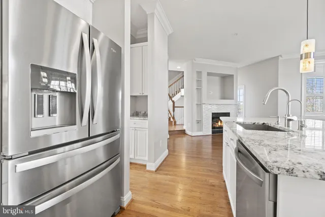 a kitchen with stainless steel appliances granite countertop a refrigerator and a stove top oven