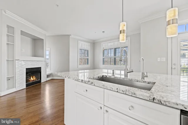a spacious bathroom with a granite countertop sink and a mirror