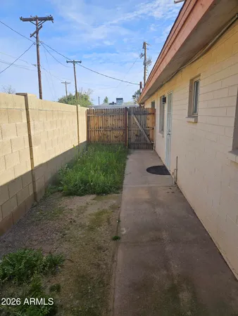 a view of a pathway of a house with a small yard