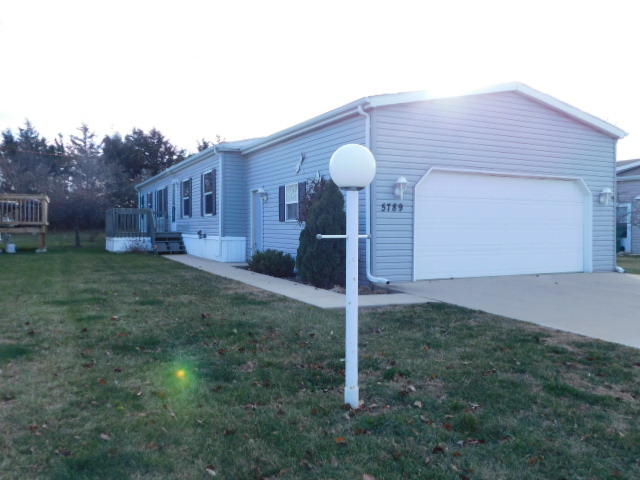 5789 Peachstone Place Loves Park, IL 61111 - Photo 1 of 28 a front view of a house with garden