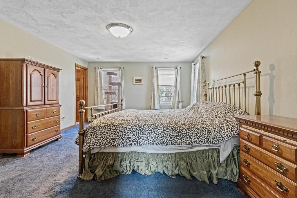 2 Little Farm Road Lakeville, MA 02347 - Photo 15 of 39 a bedroom with a bed and dresser with wooden floor