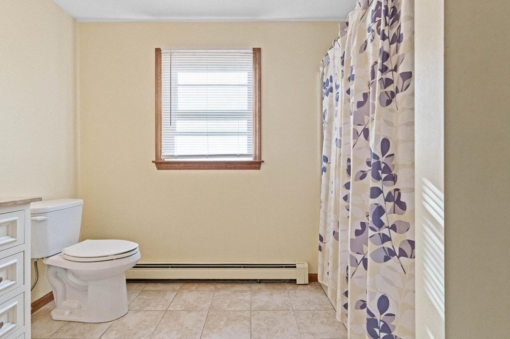 2 Little Farm Road Lakeville, MA 02347 - Photo 25 of 39 a white toilet sitting next to a shower curtain