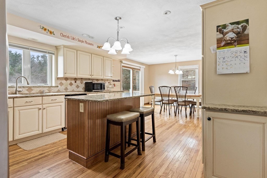 2 Little Farm Road Lakeville, MA 02347 - Photo 3 of 39 a kitchen with stainless steel appliances kitchen island granite countertop a table chairs and a refrigerator