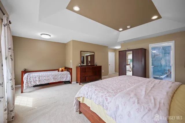 a spacious bedroom with a bed and a lamp