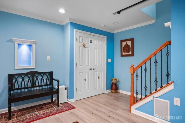 a view of a hallway with wooden floor and stairs