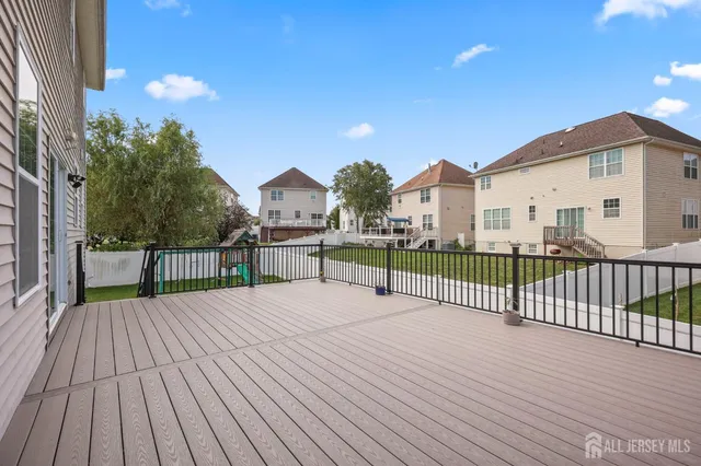 a view of a wooden deck with a yard