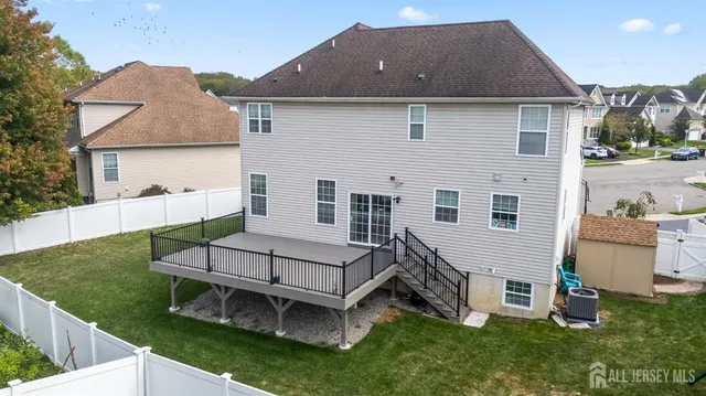 a view of a house with a yard and sitting area