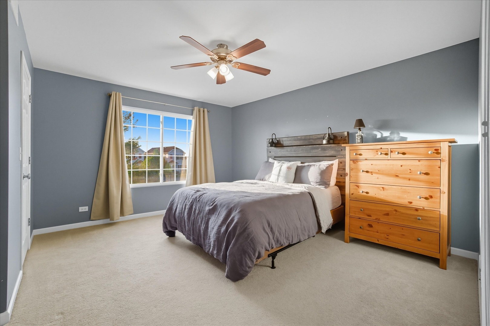 819 Daniel Drive Minooka, IL 60447 - Photo 11 of 33 a spacious bedroom with a bed and a ceiling fan