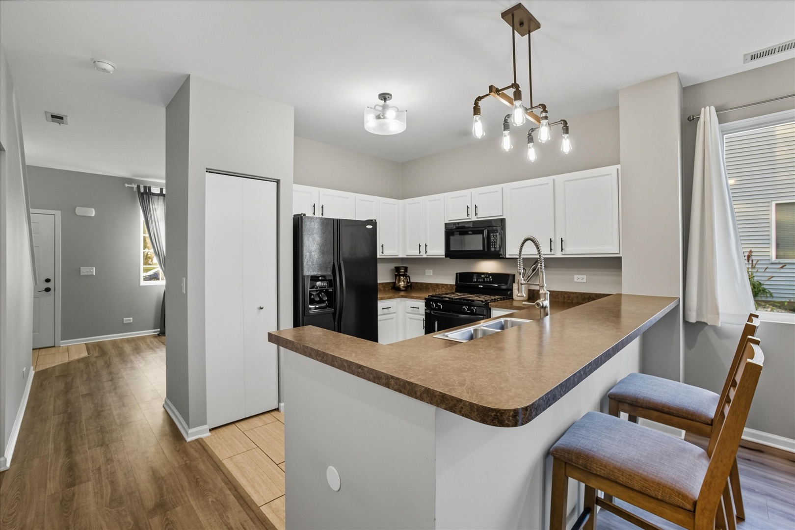 819 Daniel Drive Minooka, IL 60447 - Photo 3 of 33 a kitchen with refrigerator cabinets and wooden floor