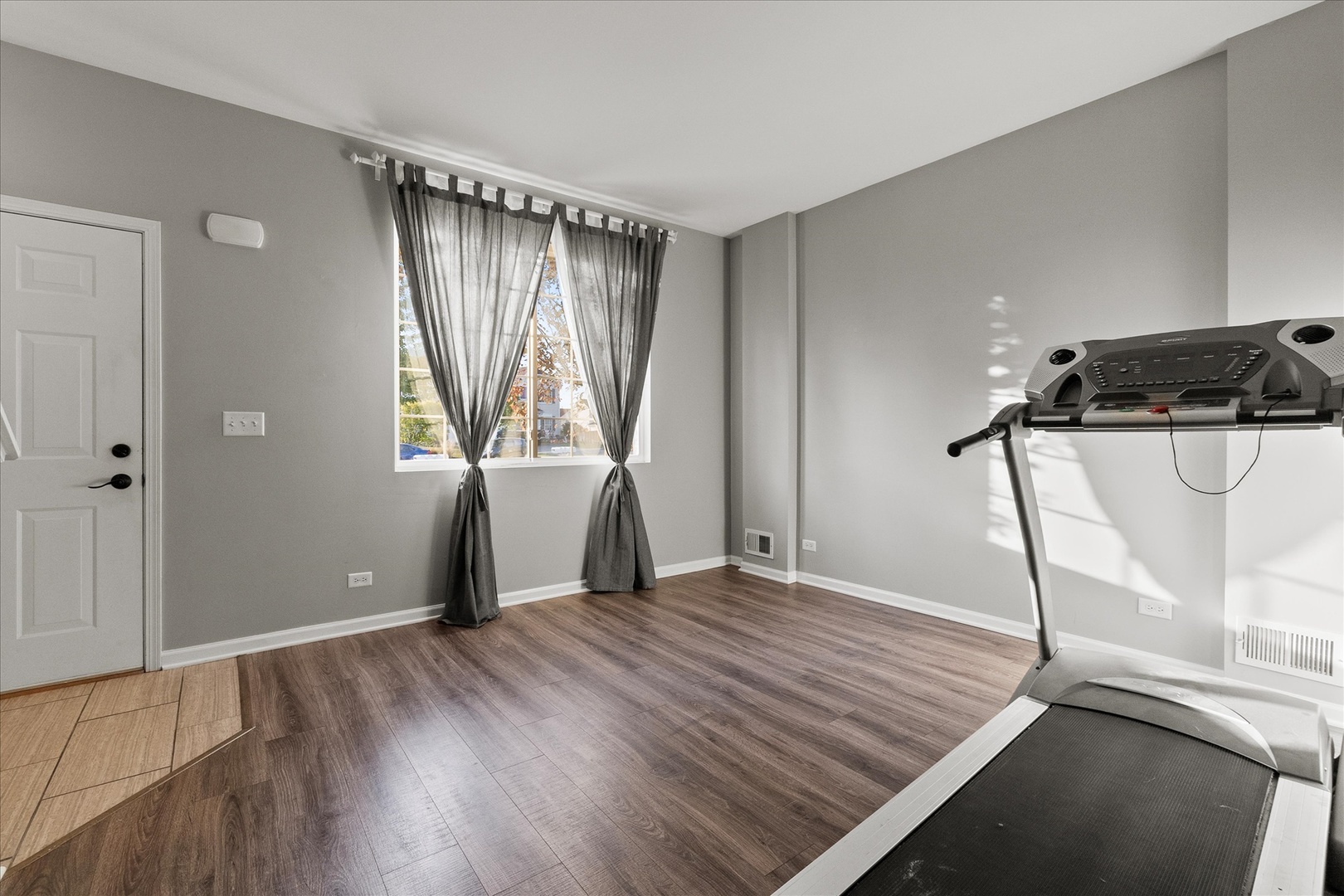 819 Daniel Drive Minooka, IL 60447 - Photo 10 of 33 a view of empty room with wooden floor and fan