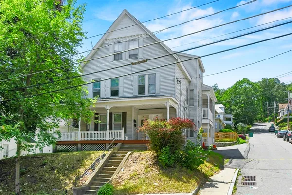 a front view of a house with garden