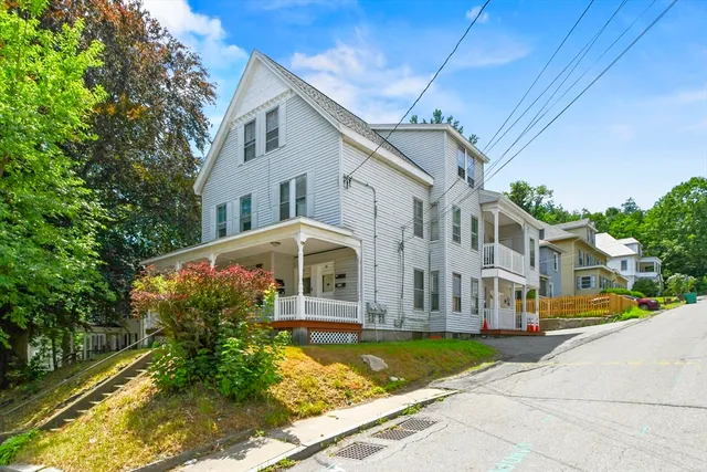 front view of a brick house with a yard