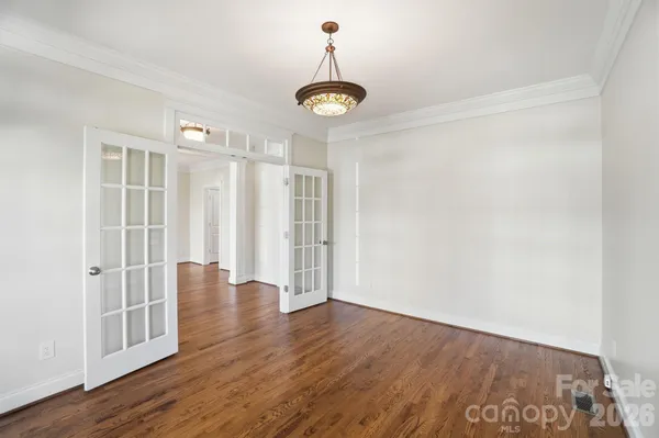 a view of walk in closet with empty racks