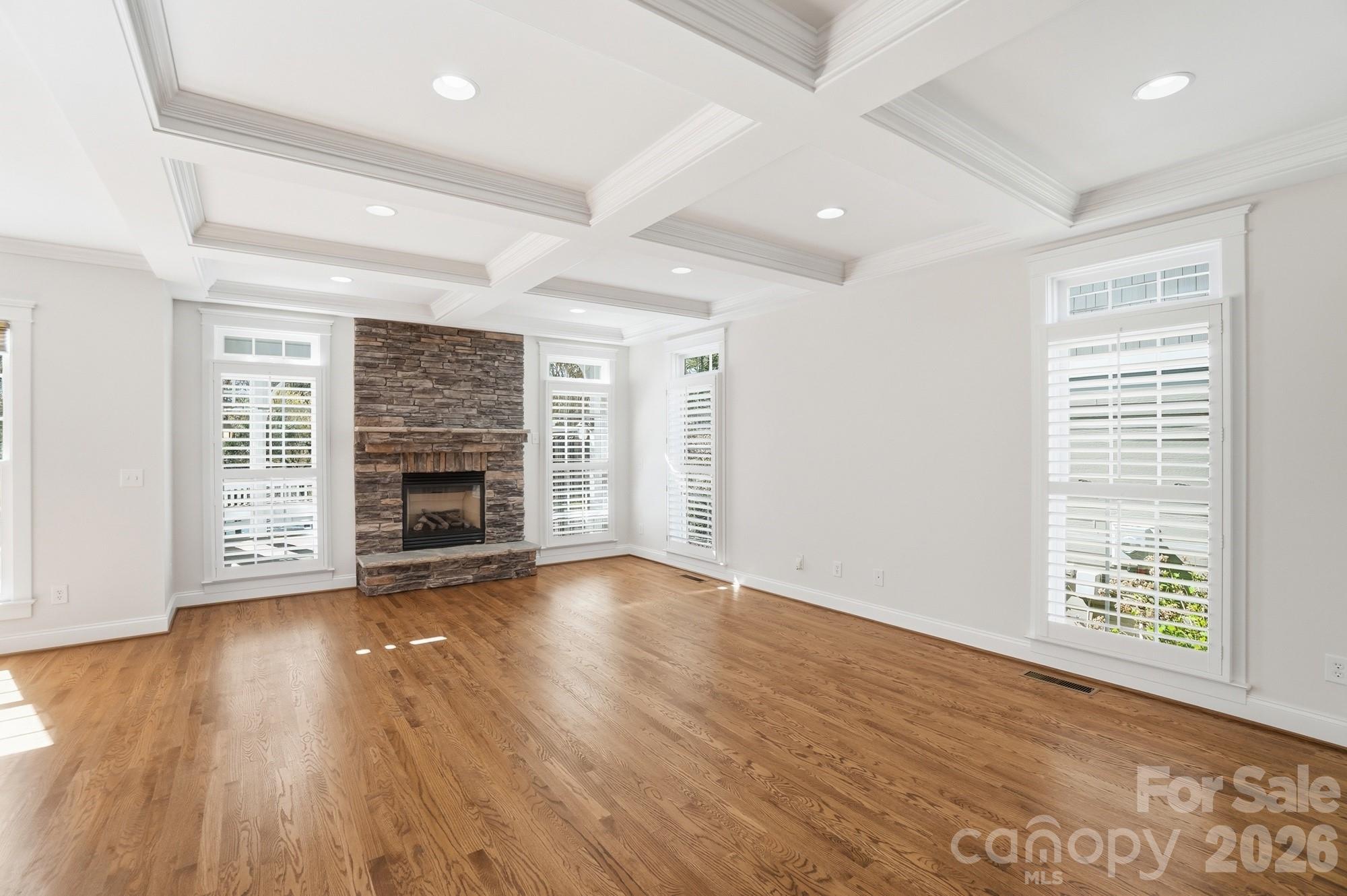 159 Lavender Bloom Loop Mooresville, NC 28115 - Photo 12 of 48 an empty room with wooden floor fireplace and windows