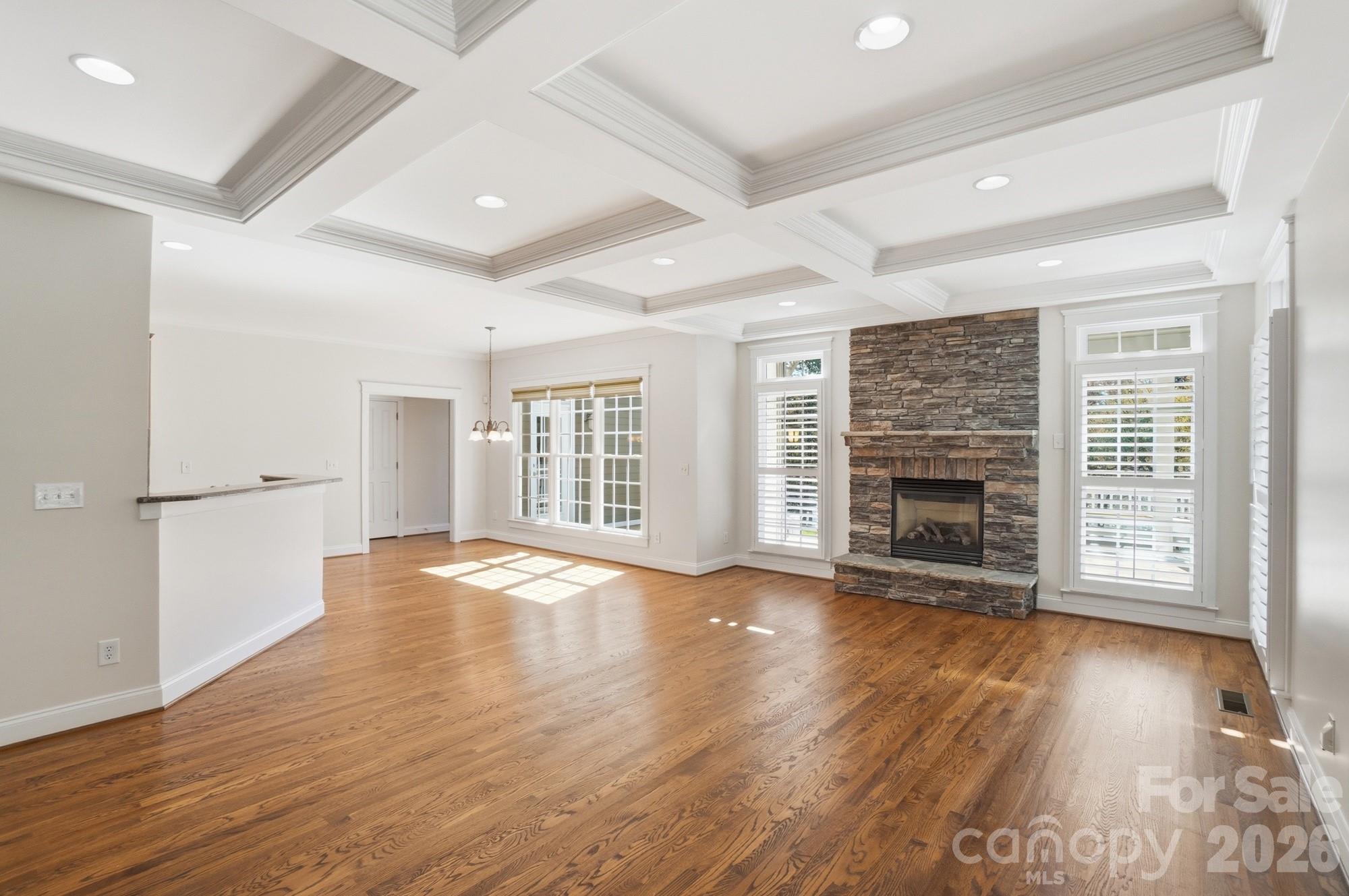 159 Lavender Bloom Loop Mooresville, NC 28115 - Photo 13 of 48 an empty room with wooden floor and fireplace