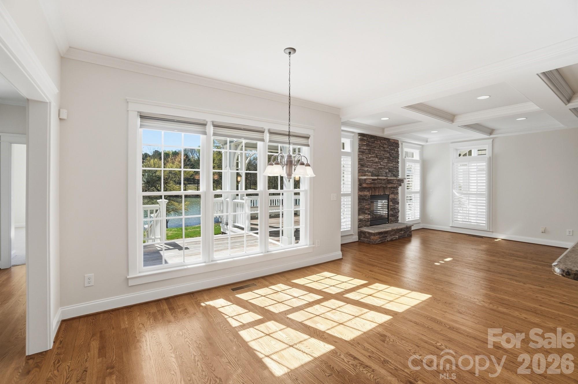 159 Lavender Bloom Loop Mooresville, NC 28115 - Photo 14 of 48 a view of an empty room with wooden floor and a window