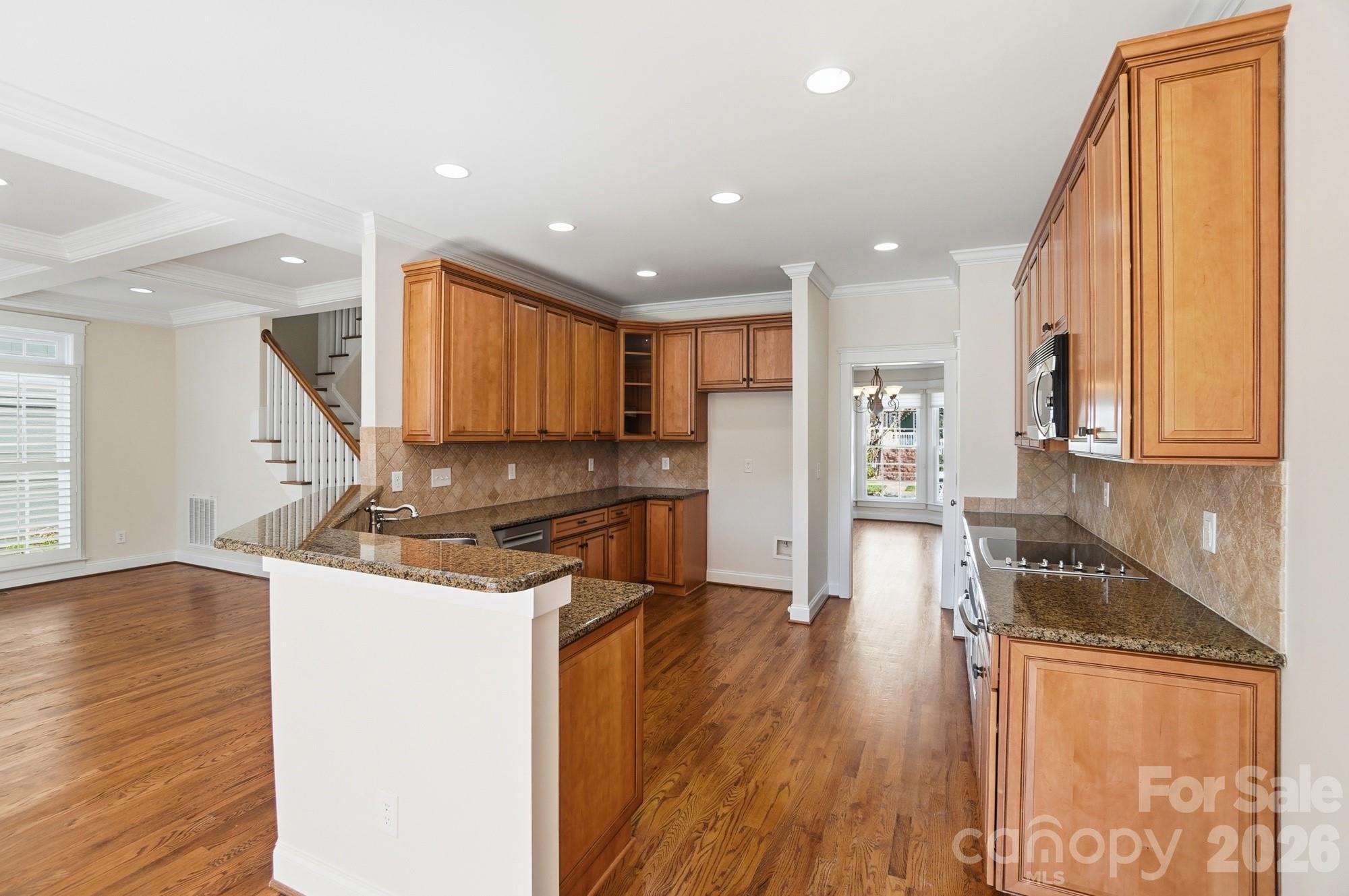 159 Lavender Bloom Loop Mooresville, NC 28115 - Photo 15 of 48 a kitchen with stainless steel appliances granite countertop a refrigerator a stove and a wooden floors