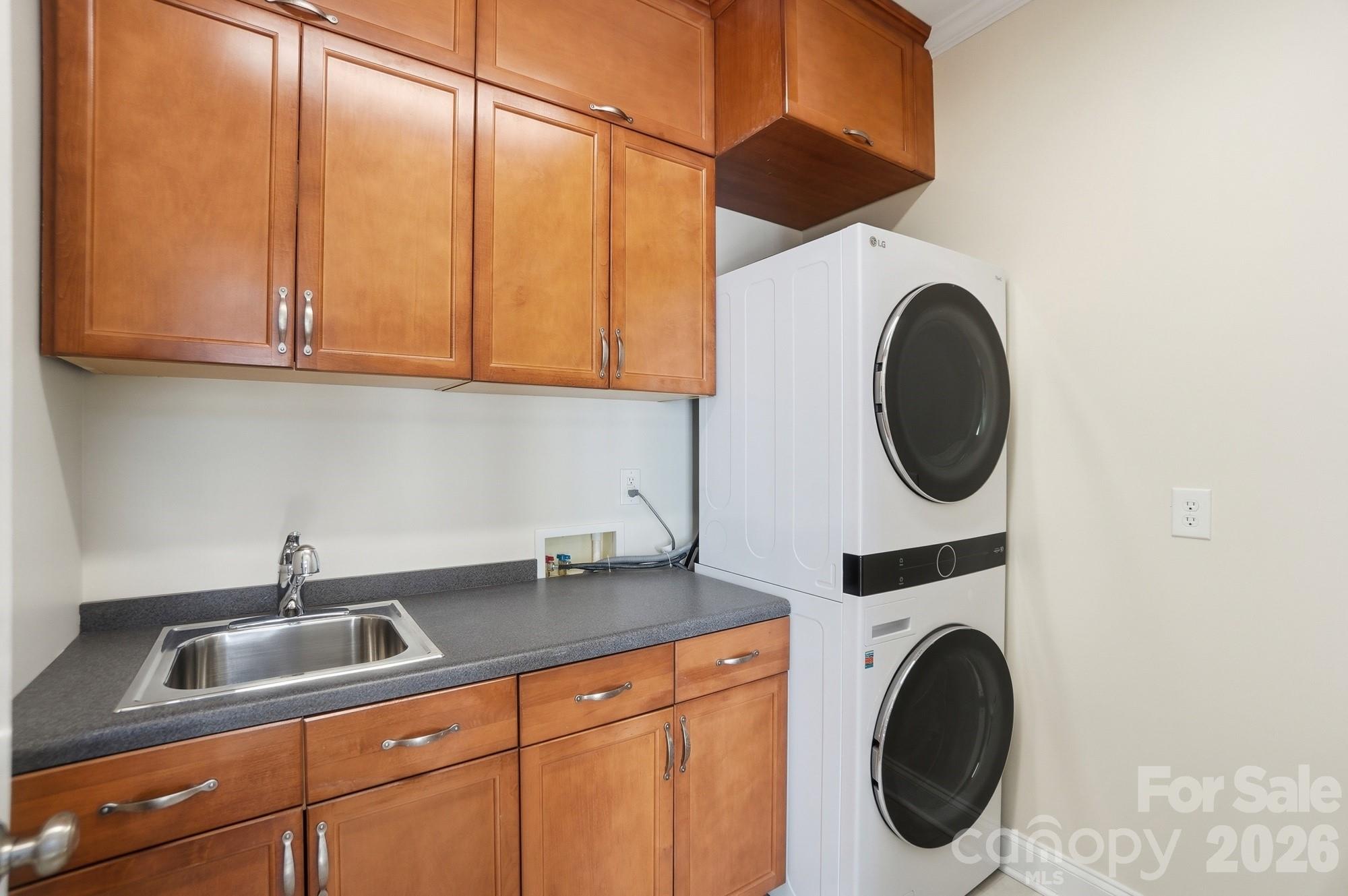 159 Lavender Bloom Loop Mooresville, NC 28115 - Photo 19 of 48 a kitchen with a sink a washer and dryer