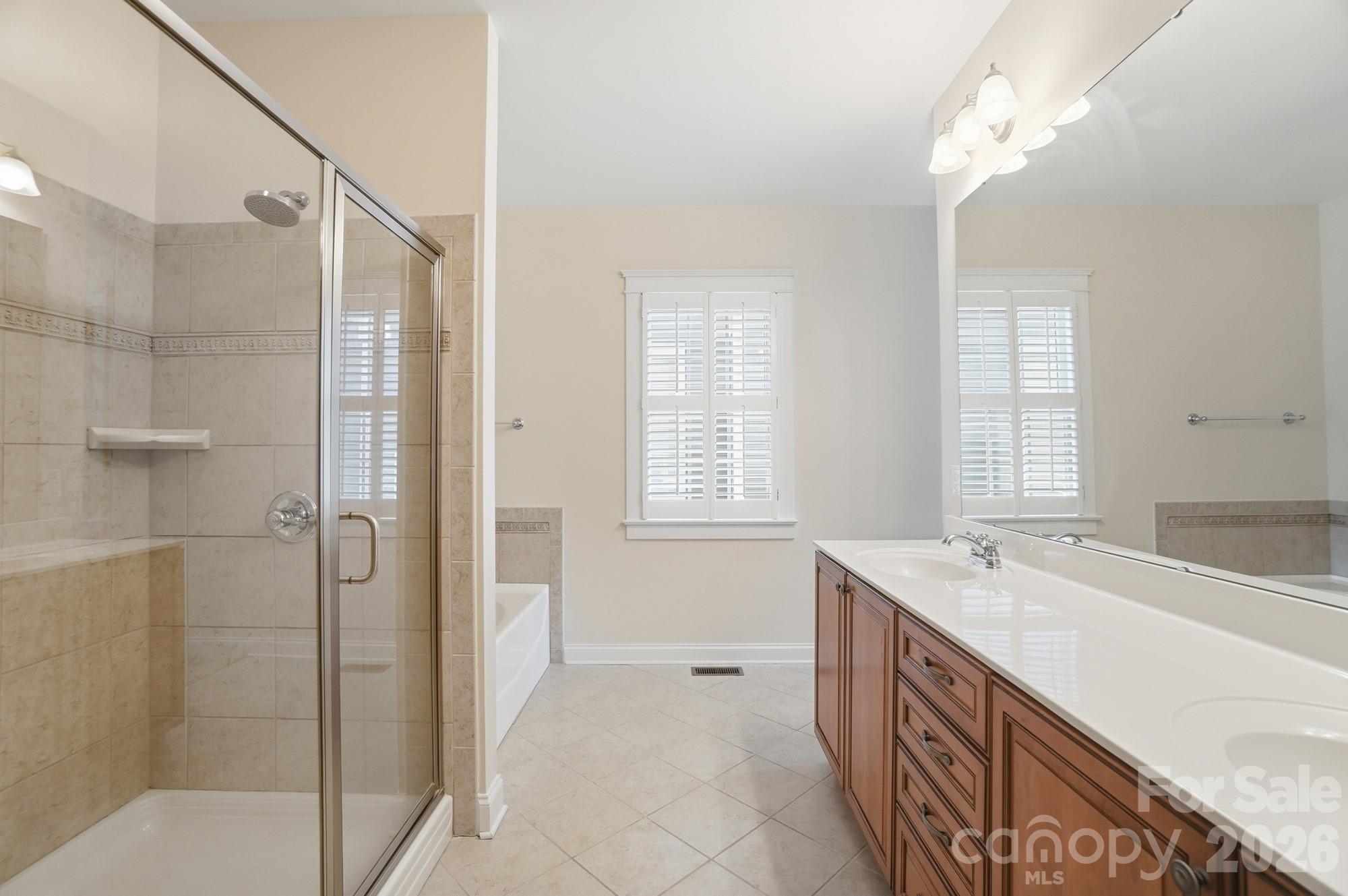 159 Lavender Bloom Loop Mooresville, NC 28115 - Photo 25 of 48 a spacious bathroom with a tub sink shower and a mirror