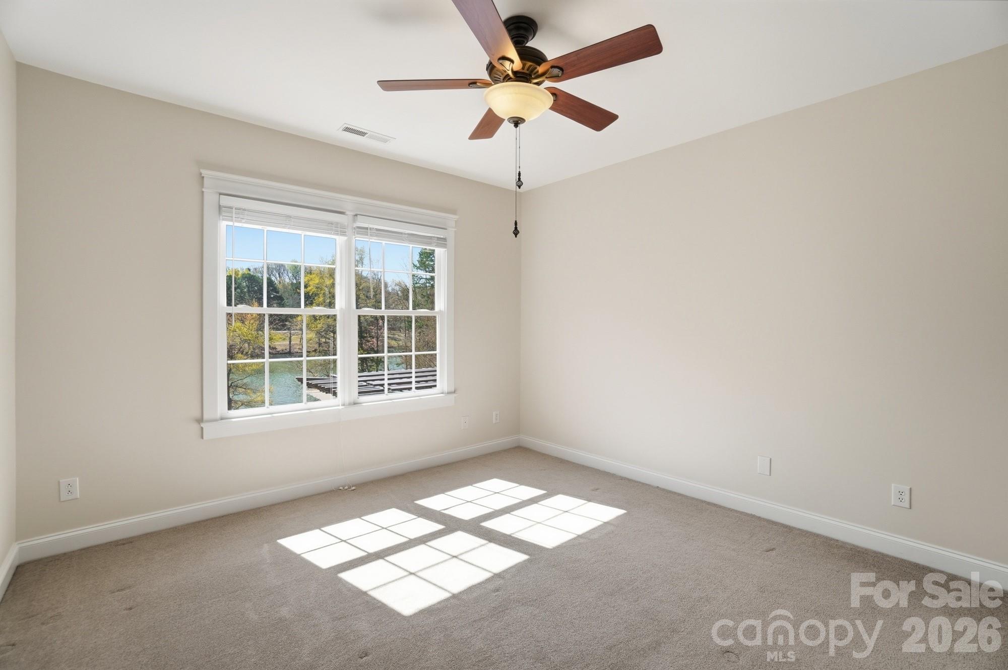 159 Lavender Bloom Loop Mooresville, NC 28115 - Photo 29 of 48 an empty room with windows and fan