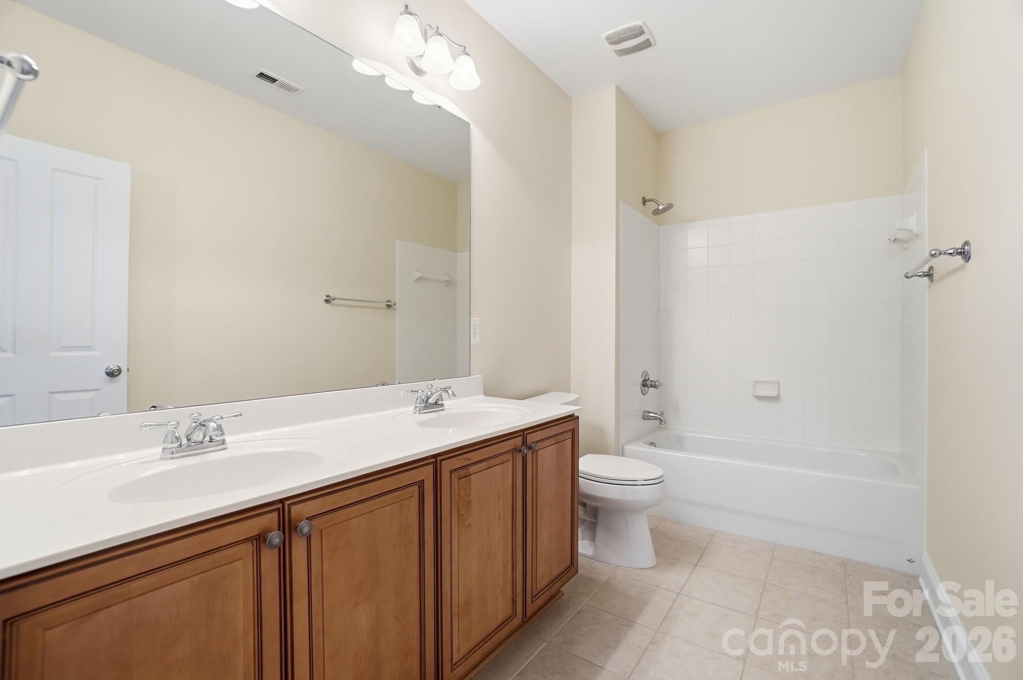159 Lavender Bloom Loop Mooresville, NC 28115 - Photo 30 of 48 a bathroom with a double vanity sink toilet and a mirror