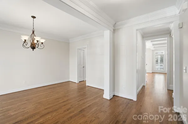 a kitchen with stainless steel appliances granite countertop a stove a sink and white cabinets with wooden floor