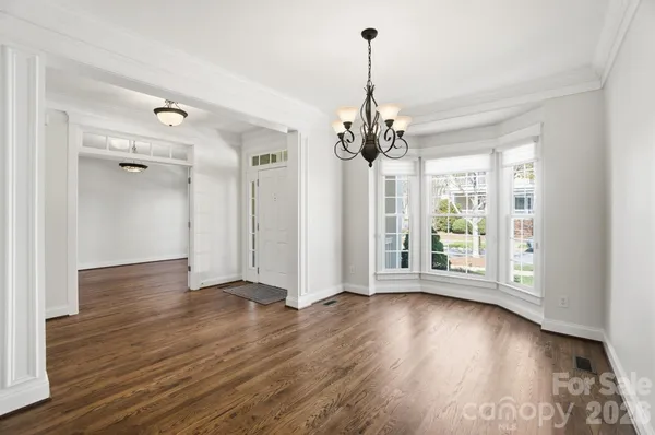 a white kitchen with granite countertop stainless steel appliances