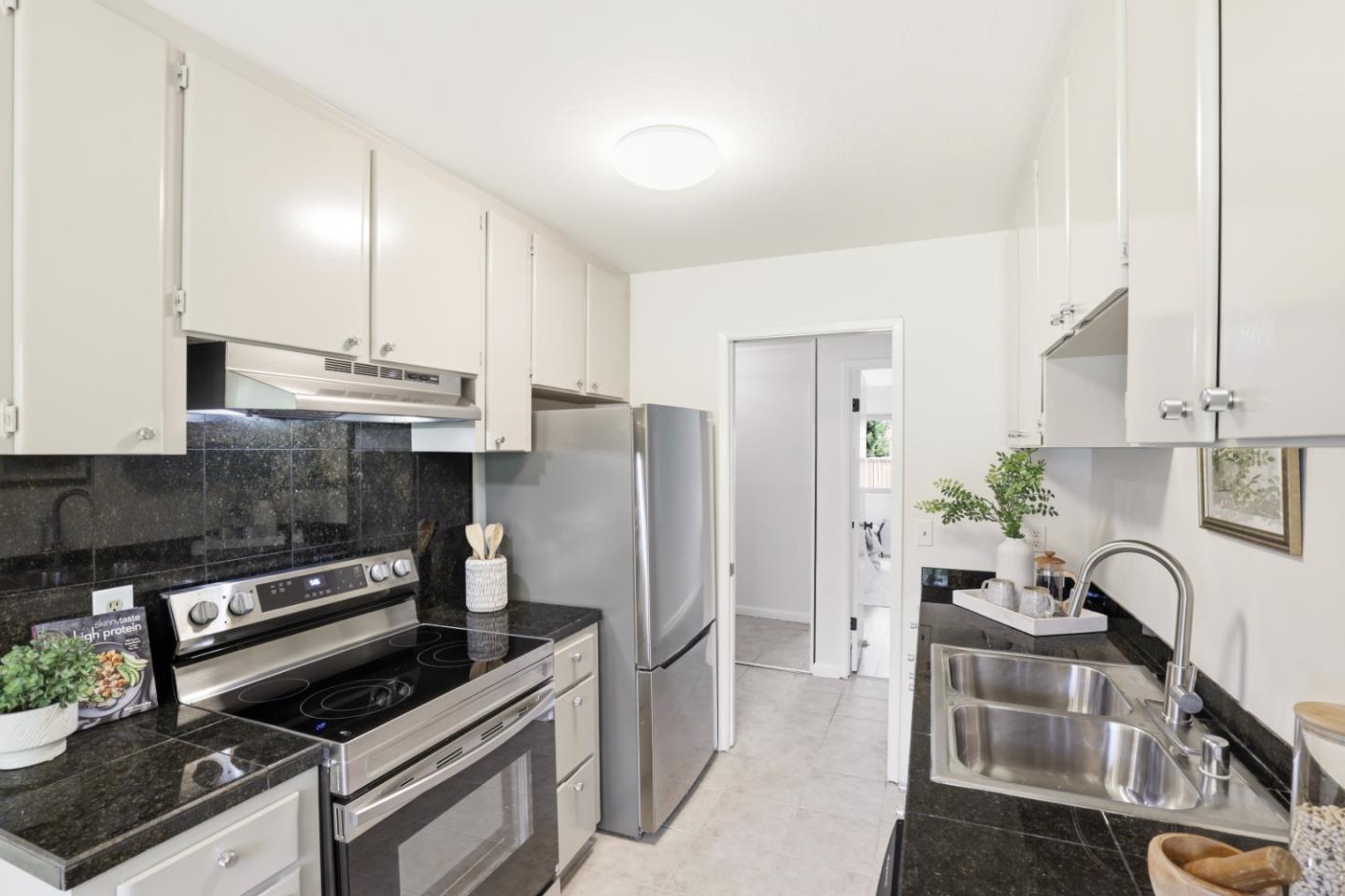 100 East Middlefield Road, Unit 3B Mountain View, CA 94043 - Photo 9 of 32 a kitchen with stainless steel appliances a stove a sink a refrigerator and cabinets