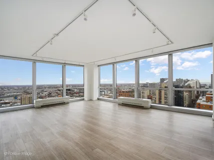 a view of room with wooden floor and floor to ceiling window