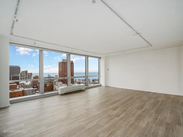 an empty room with large windows