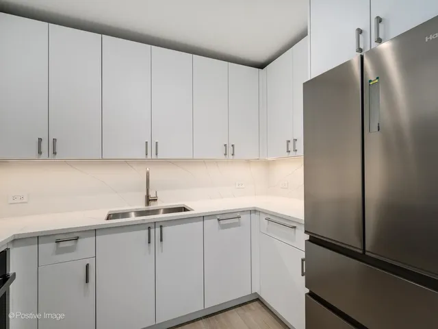 a kitchen with a sink and cabinets