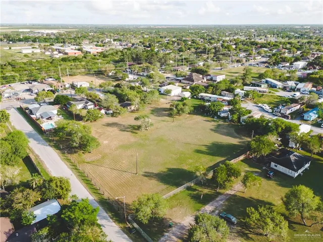 an aerial view of residential houses with outdoor space and river