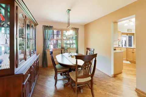 a dining room with furniture a chandelier and window