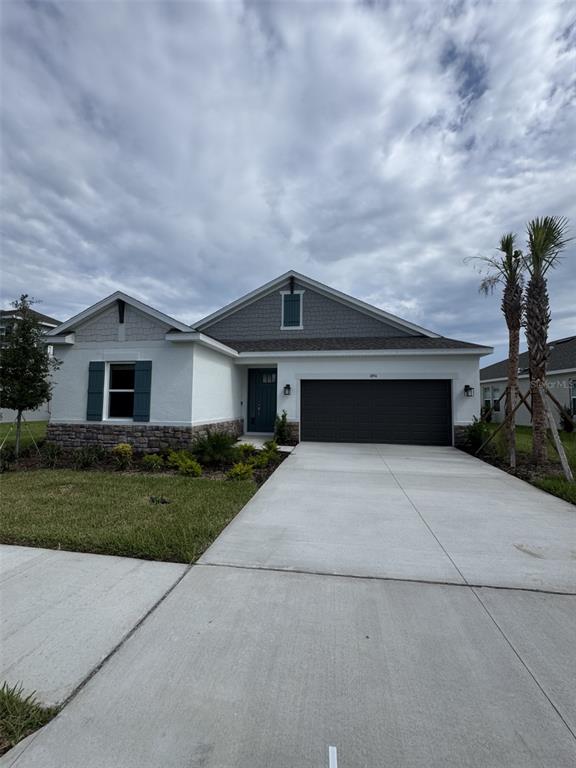 1894 Longliner Loop Wesley Chapel, FL 33543 - Photo 1 of 1 a front view of a house with a yard and garage