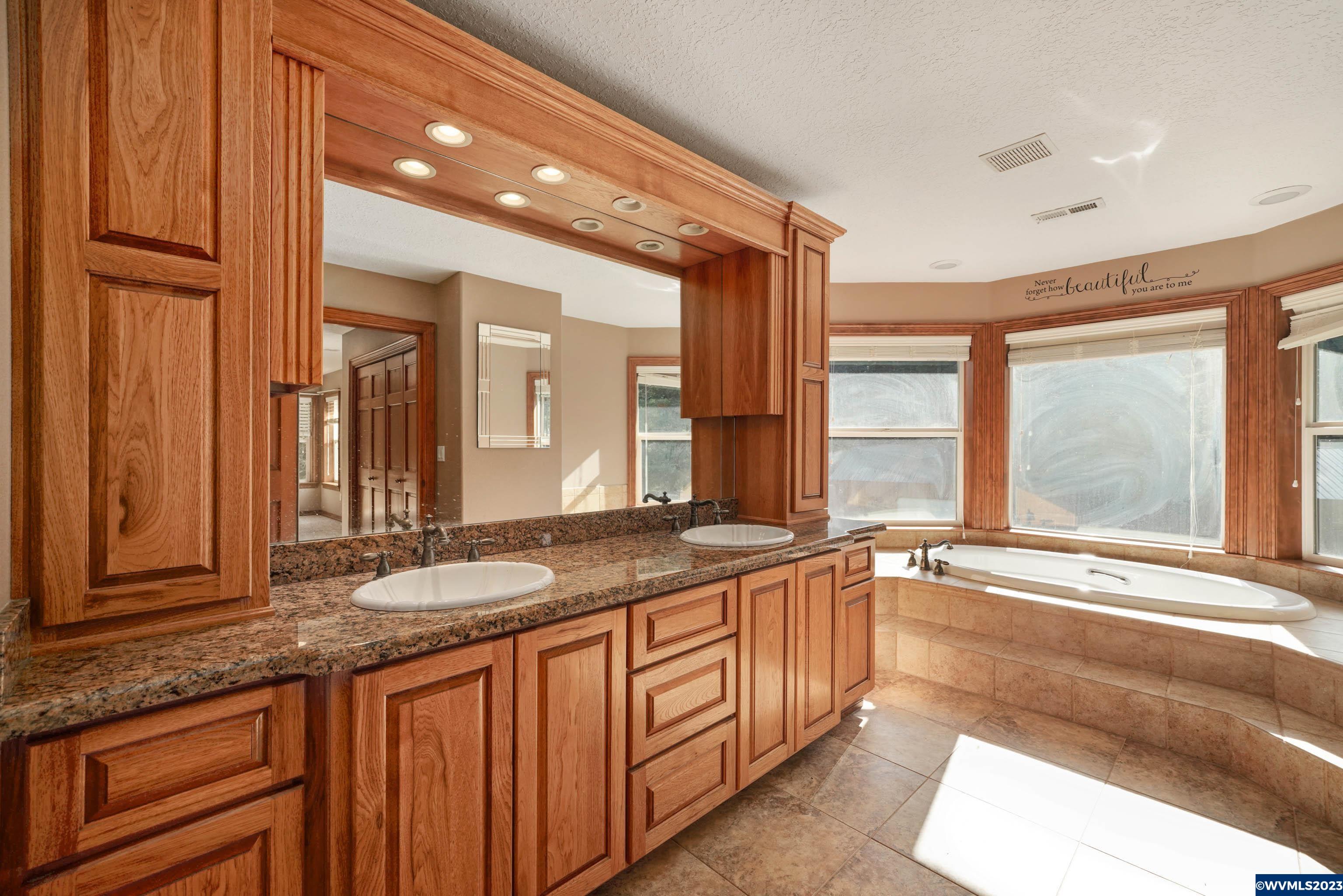 16570 Oakdale Road Dallas, OR 97338 - Photo 28 of 41 a bathroom with a granite countertop sink and a large mirror