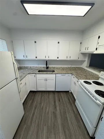 a kitchen with a white cabinets and white appliances