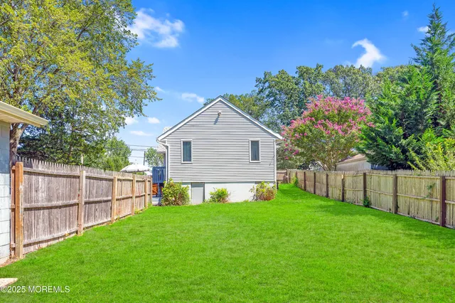 a view of a house with a yard and sitting area