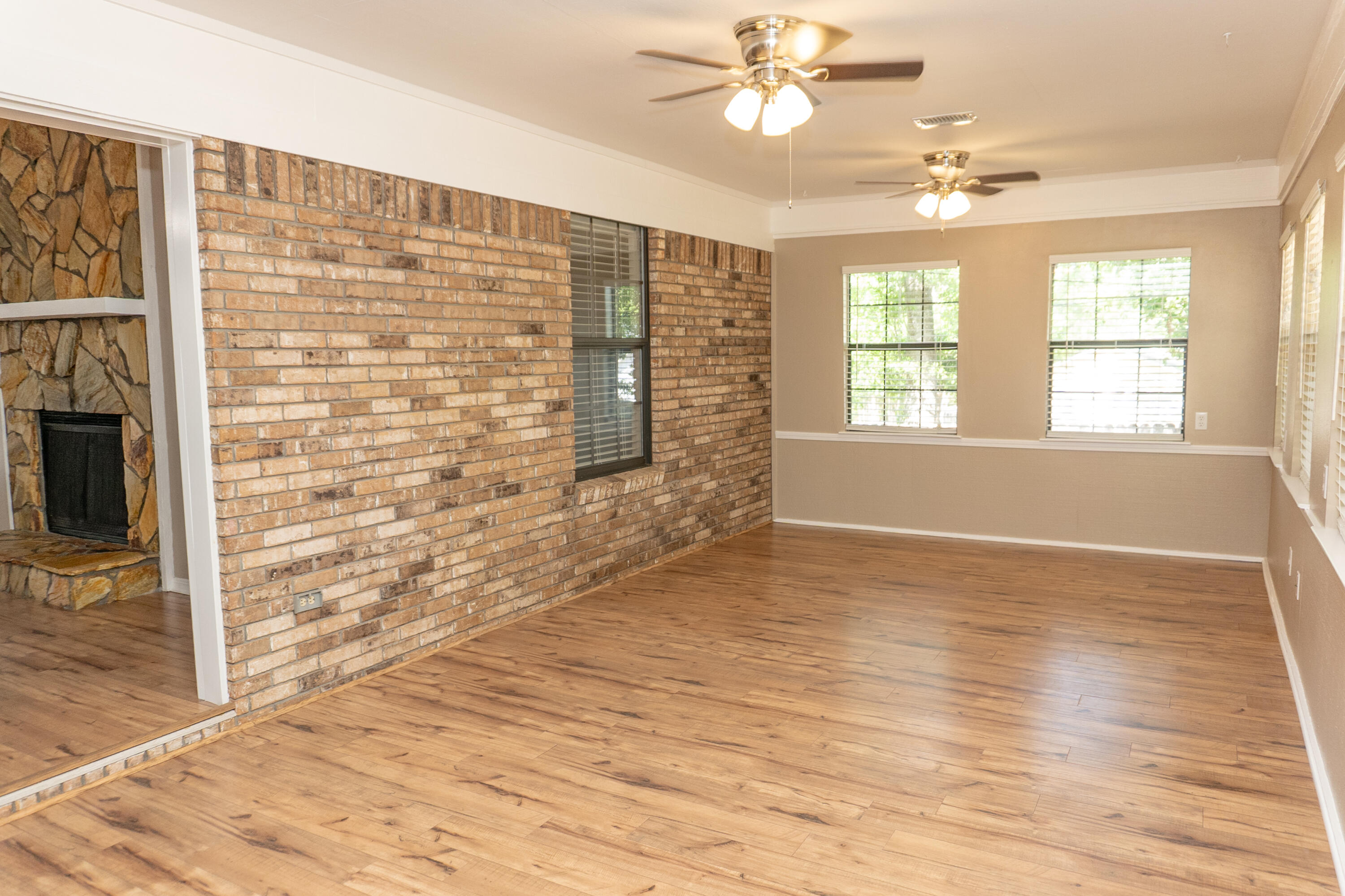 102 Brian Drive Crestview, FL 32536 - Photo 13 of 23 a view of an empty room with wooden floor and a window