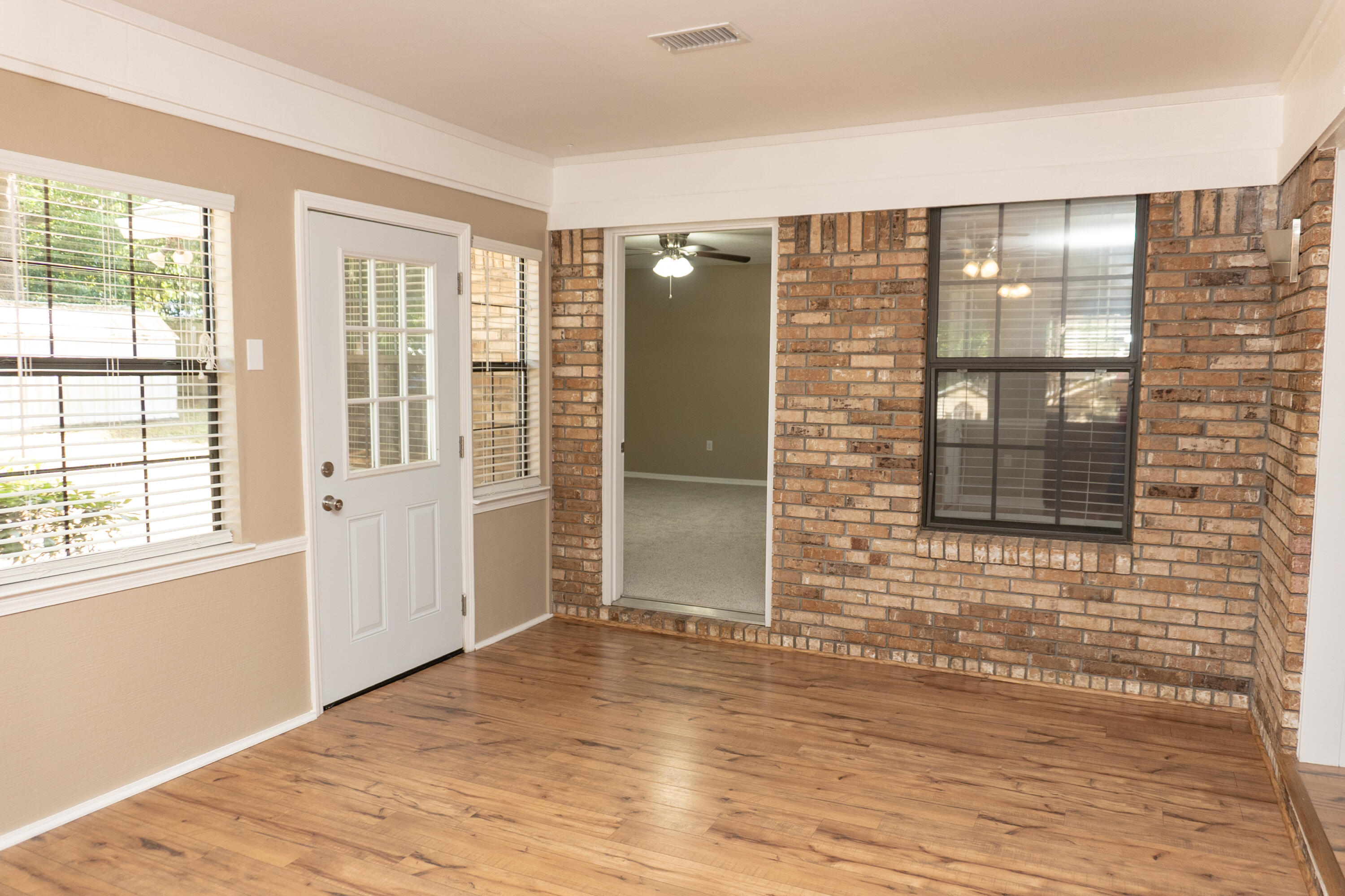 102 Brian Drive Crestview, FL 32536 - Photo 15 of 23 a view of an empty room with wooden floor and windows