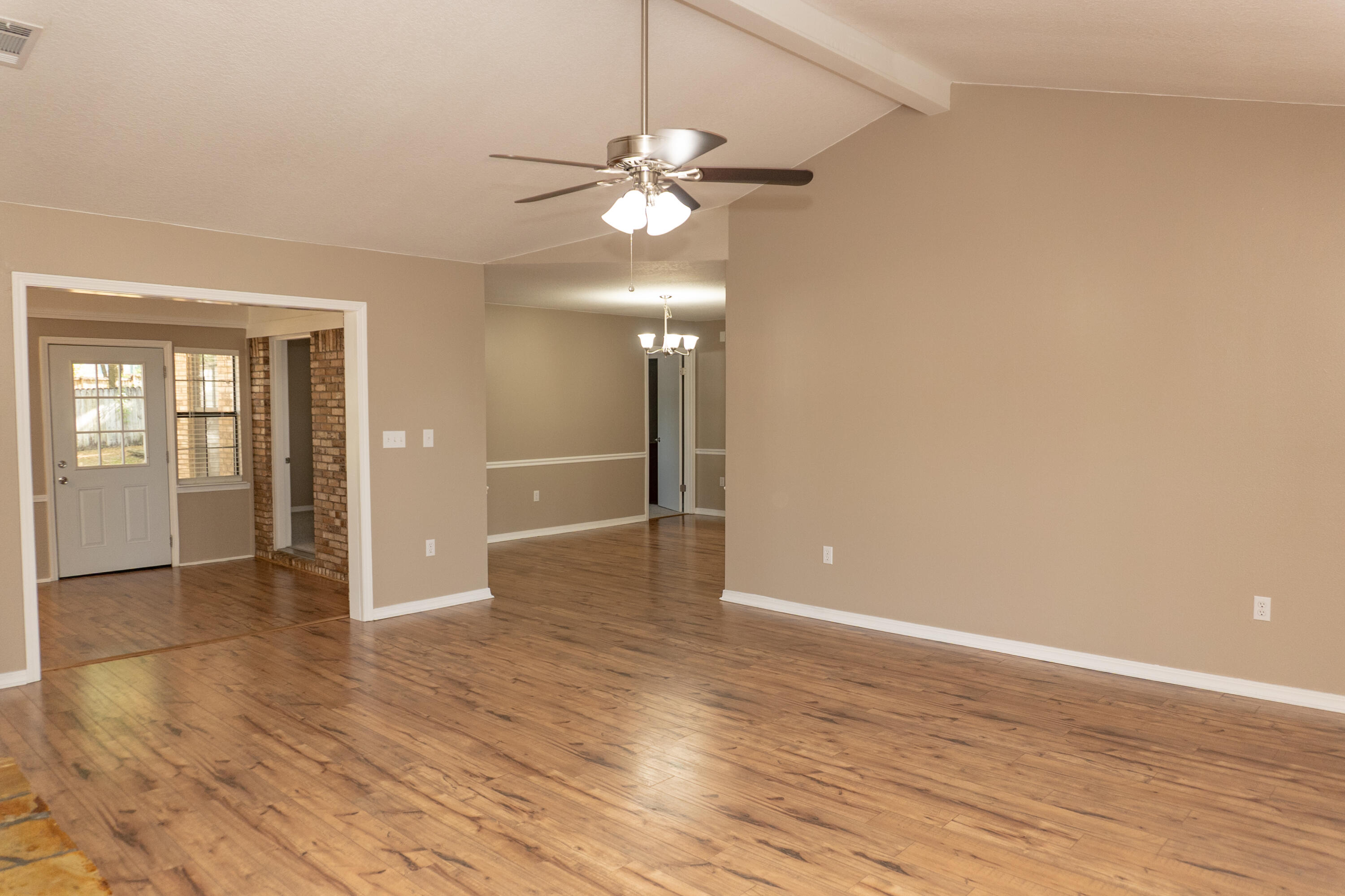 102 Brian Drive Crestview, FL 32536 - Photo 2 of 23 wooden floor in an empty room with a window