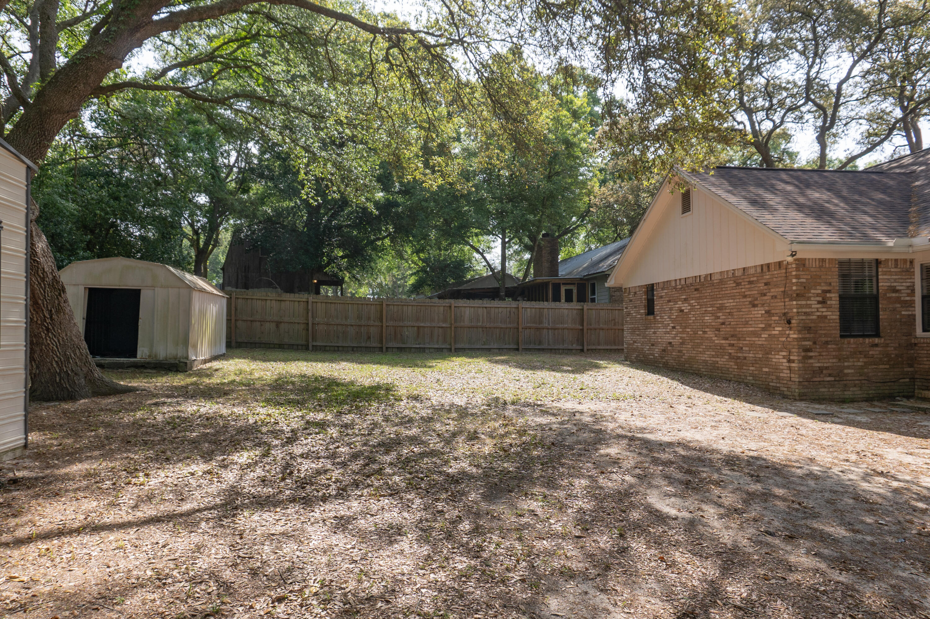 102 Brian Drive Crestview, FL 32536 - Photo 23 of 23 a backyard of a house with a large tree