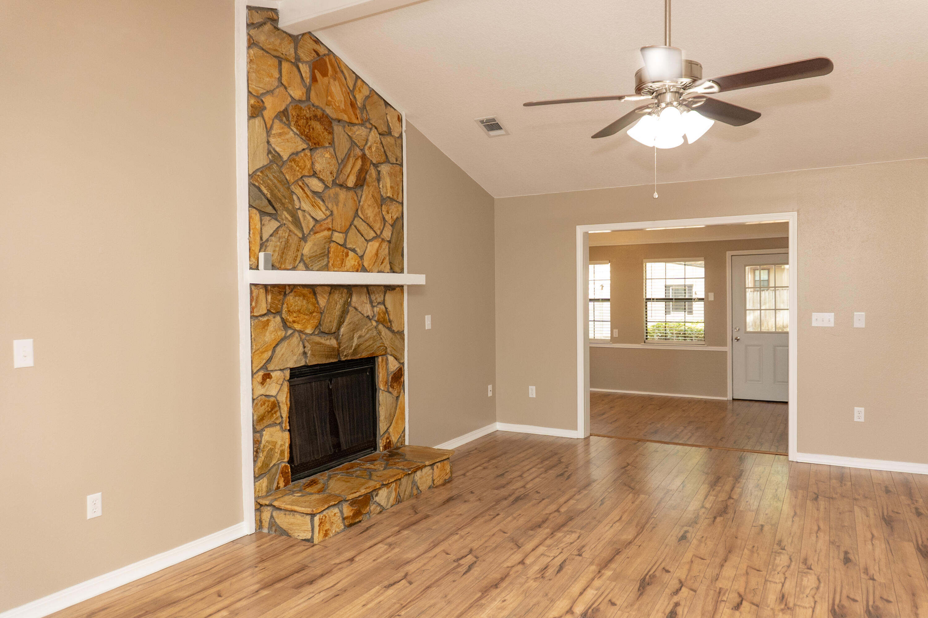 102 Brian Drive Crestview, FL 32536 - Photo 3 of 23 a view of an empty room with wooden floor and a window