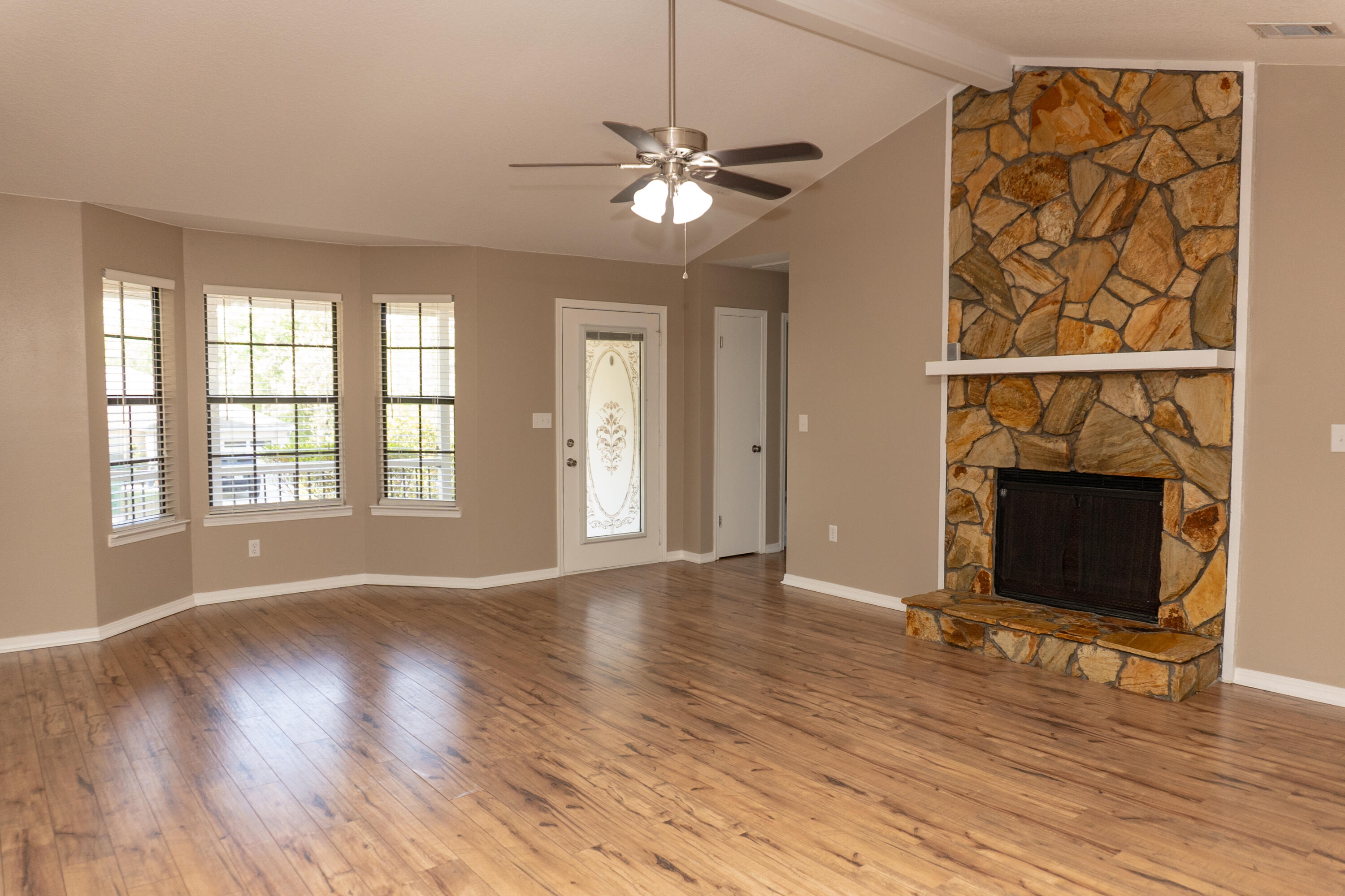 102 Brian Drive Crestview, FL 32536 - Photo 4 of 23 a view of an empty room with wooden floor and a window