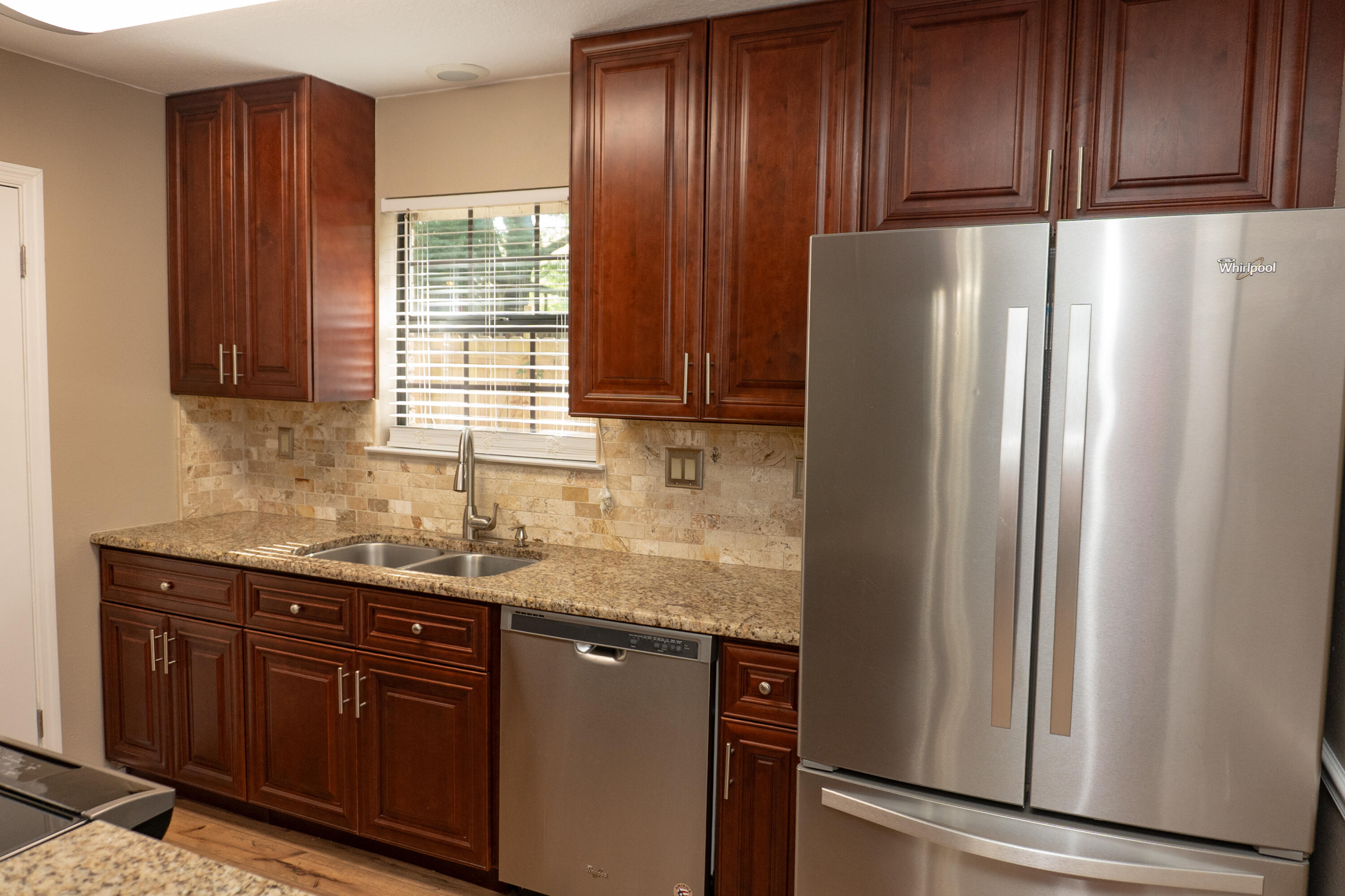 102 Brian Drive Crestview, FL 32536 - Photo 7 of 23 a kitchen with granite countertop stainless steel appliances a refrigerator and a sink