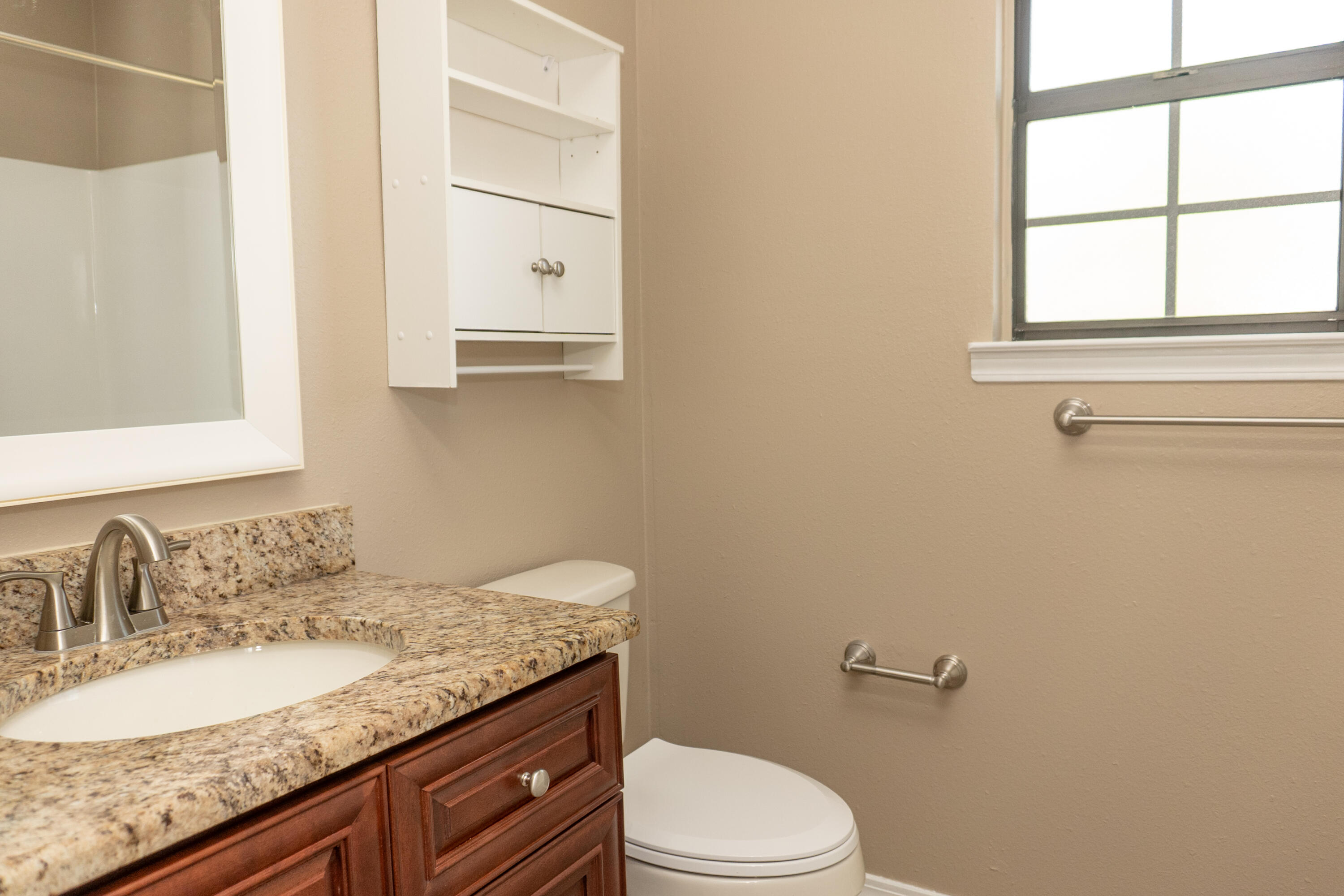 102 Brian Drive Crestview, FL 32536 - Photo 10 of 23 a bathroom with a granite countertop sink toilet and mirror